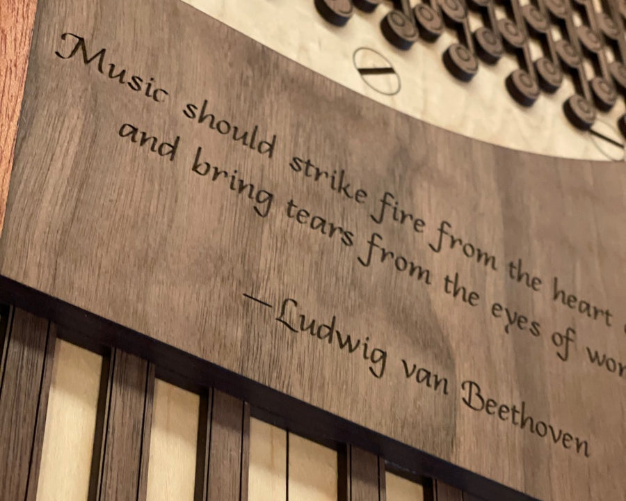Laser-cut wood piano wall art with an engraved Beethoven quote