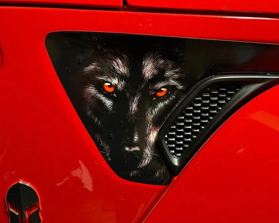 Full-color wolf decal on the hood vent of a red Jeep Gladiator