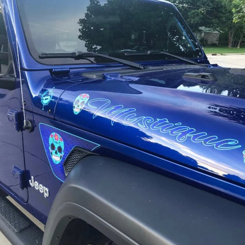 Sugar skull decals and lettering on a Jeep